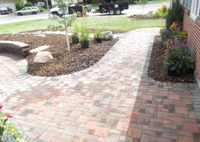 Split Paver pathway with accent rock planting areas and retaining wall