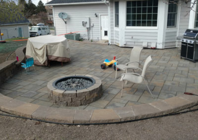 Circular recessed patio with raised embedded fire pit